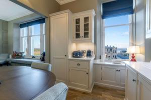 a kitchen with a dining table and a window at 20 Golf Place in St. Andrews