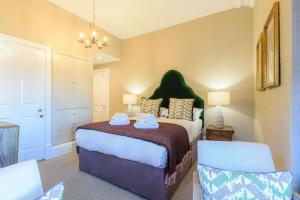 a bedroom with a bed with two towels on it at 20 Golf Place in St. Andrews +19 photos
