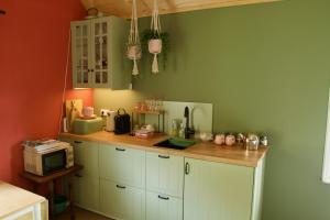 a kitchen with white cabinets and a counter top at Theetuin en B & B 'De Theetuin' in Wijckel