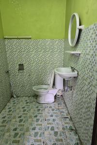 a bathroom with a toilet and a sink at Malai Place Lampang in Lampang +28 photos