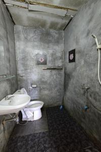 a bathroom with a white toilet and a sink at Malai Place Lampang in Lampang