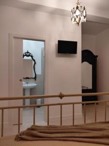 a bedroom with a bed and a chandelier at Lacerno Rooms in Pescosolido