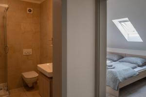 a small bathroom with a bed and a shower at Apartmány Pelech in Martinske Hole +51 photos