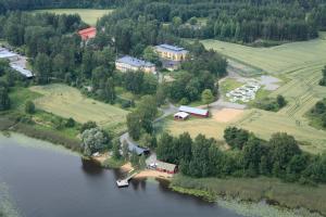 an aerial view of a house next to a lake at Kyyhkylä Hotel and Manor in Mikkeli
