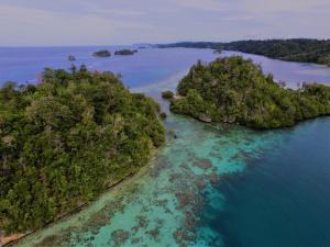 an aerial view of a group of islands in the ocean at Kadidiri Paradise in Batudaka