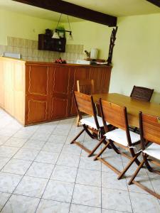 a kitchen with a wooden table and chairs at Vila close to Bran Castle in Moieciu de Jos