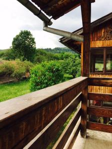 a porch of a wooden house with a view at Vila close to Bran Castle in Moieciu de Jos