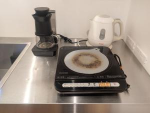 a scale sitting on a counter with a coffee maker at Shizuya KYOTO in Kyoto