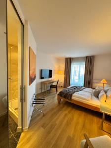 a hotel room with a bed and a desk at Plaza Rooms & Studios in Forchheim