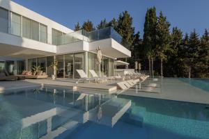 a large house with a swimming pool in front of it at Villa Lazareto in Kontokali