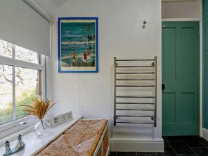 a kitchen with a green door and a towel ladder at 2 Bed in Blaenau Ffestiniog oc-86064 in Maentwrog