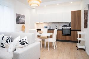 a living room and kitchen with a table and a couch at The Castle Apartment in Brescia +12 photos