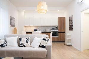 a living room with a couch and a kitchen at The Castle Apartment in Brescia