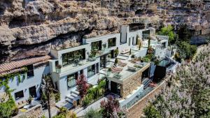 an aerial view of a house with a cliff at XUQ Hotels Lomas de Ruvira in Jorquera