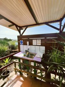 an outdoor kitchen with a sink under a pergola at Agrocamping Invernaderito in Tejina