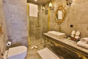 a bathroom with a sink toilet and a mirror at REAL KiNG SUiTE in Trabzon