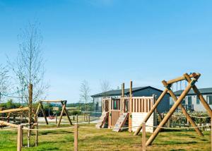 a park with an empty playground with a building at Penmarlam Lodge Retreat in Fowey +149 photos