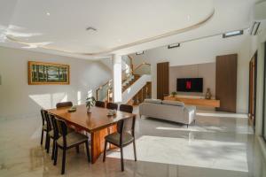 a living room with a table and chairs and a couch at Villa 234 Yogyakarta in Yogyakarta