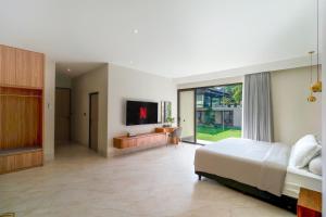 a bedroom with a bed and a living room at Villa 234 Yogyakarta in Yogyakarta +32 photos