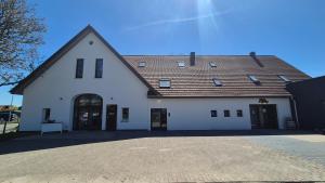 a large white building with a brown roof at Ferienwohnung Melle - Westerhausen in Melle
