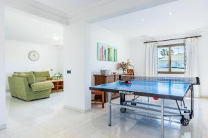 a ping pong table in a living room at Llenaire Gran Beach House in El Port +27 photos