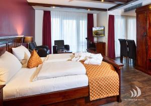 a bedroom with a large bed in a room at Riverside Hotel in Nordhorn +33 photos