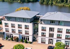 an aerial view of two buildings and a river at Riverside Hotel in Nordhorn
