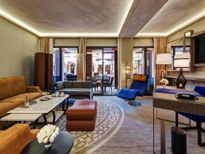 a living room with a couch and a table at Mövenpick Hotel Mansour Eddahbi Marrakech in Marrakech