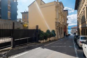 a building with a fence on the side of a street at Casa Niky in Verbania