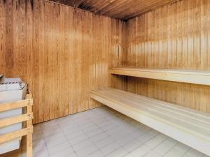 a sauna with wooden walls and wooden shelves at 4 person holiday home on a holiday park in Faaborg in Faaborg
