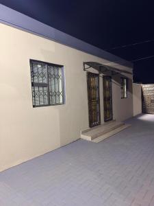 an empty building with two windows and a porch at Iyana Lodge in Grasmere +11 photos