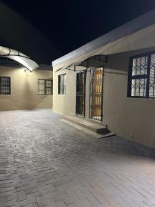 an empty building with a brick courtyard at night at Iyana Lodge in Grasmere