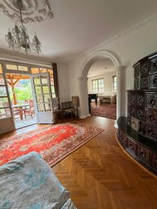 a living room with a bed and a rug at Ágnes Nyaralóház in Siófok