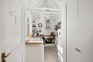 a kitchen with white appliances and a white ceiling at Heywood Cottage in St. Andrews