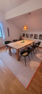 a dining room with a wooden table and chairs at Premium Apartment - großzügig & zentral wohnen in Schwarzenberg