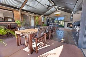a dining room with a wooden table and chairs at Maffra Retreat in Maffra