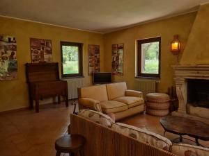 a living room with a couch and a piano at Casale Pomodoro in Manziana +36 photos