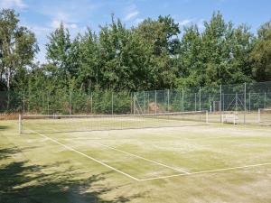 a tennis court with a net on at 6 person holiday home in Væggerløse in Bøtø By +84 photos