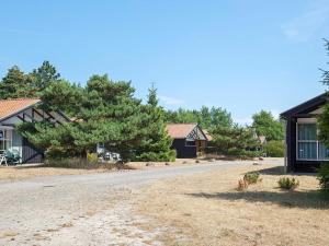 an empty road in front of a house at 6 person holiday home in Væggerløse in Bøtø By