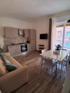 a living room with a couch and a dining room table at Bilocale nuovissimo! A due passi dal mare! in Levanto +5 photos
