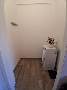 a room with a toilet with a flower pot on it at Bilocale nuovissimo! A due passi dal mare! in Levanto