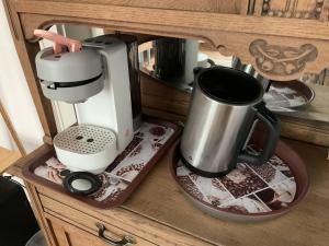 a coffee maker on a tray on a wooden cabinet at Elfenvilla in Erkelenz