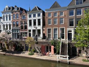 a group of buildings next to a river at Wilsons in Utrecht