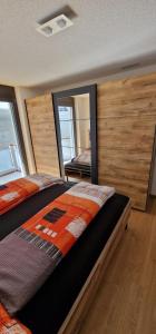 a bedroom with two beds and a large mirror at Bergperle in Grächen