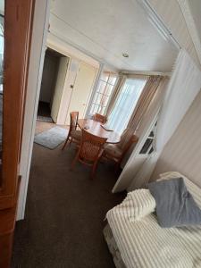 a bedroom with a desk and a table and a bed at Home from home in Ingoldmells
