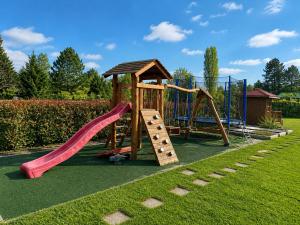 a playground with a slide and a swing set at DIÓFA APARTMAN in Pilismarót