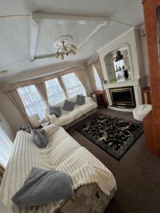 a living room with two beds and a fireplace at Home from home in Ingoldmells