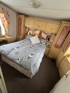a bedroom with a bed in an rv at Home from home in Ingoldmells