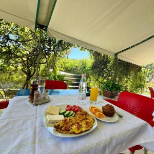 a table with a plate of food on top at Villa Niku Berat in Berat +46 photos
