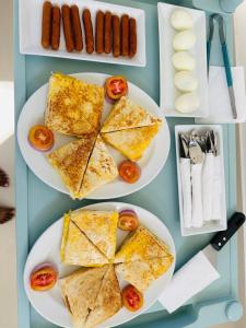a table with three plates of food on plates at Hotel Elysian in Udawalawe